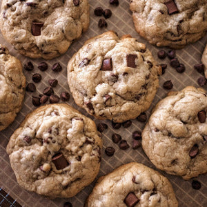 Freshly baked chocolate chip cookies cooling on a wire rack.