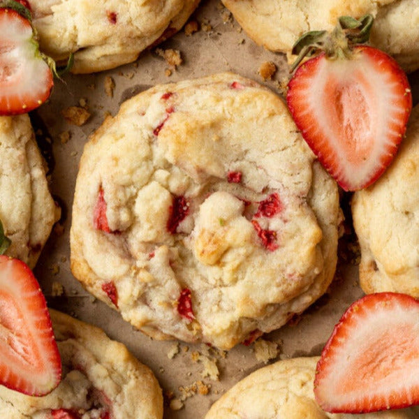 Strawberry cookies with fresh strawberries on a baking sheet